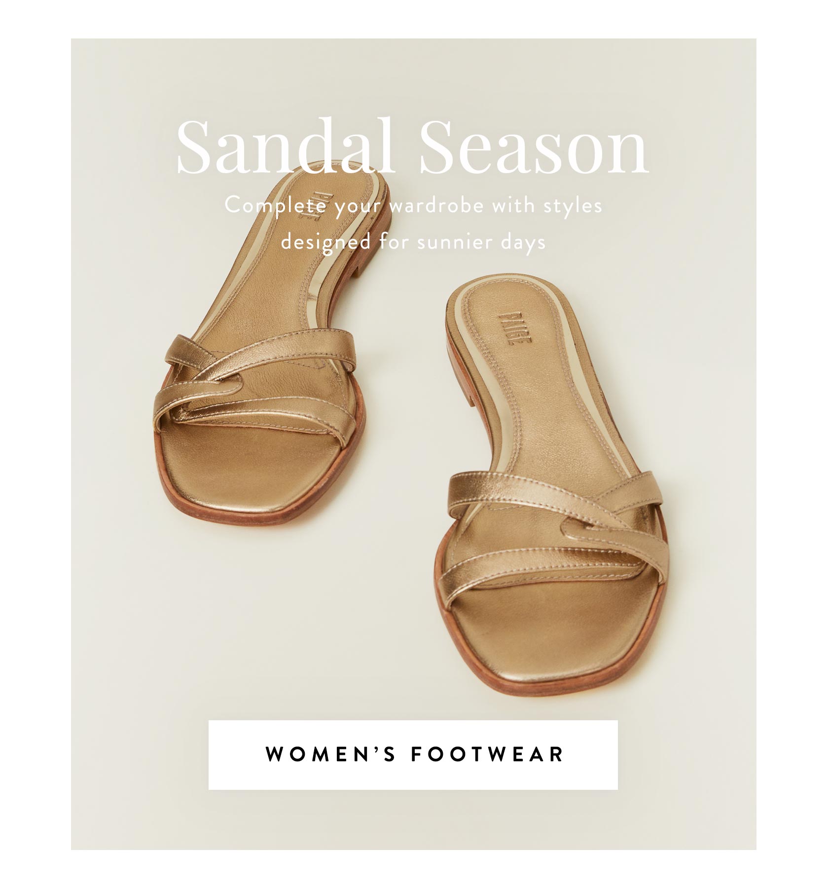 A pair of gold leather sandals sat side by side on a cream colored floor