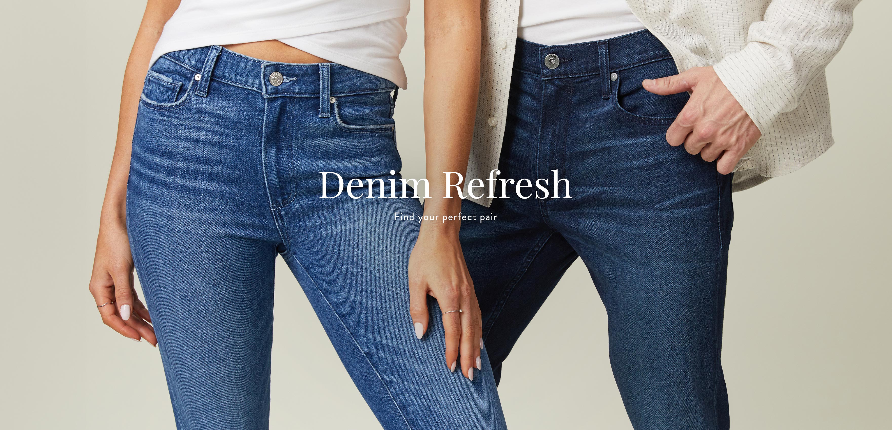 Detail shot of man and woman standing next to each other wearing different shades of blue denim jeans